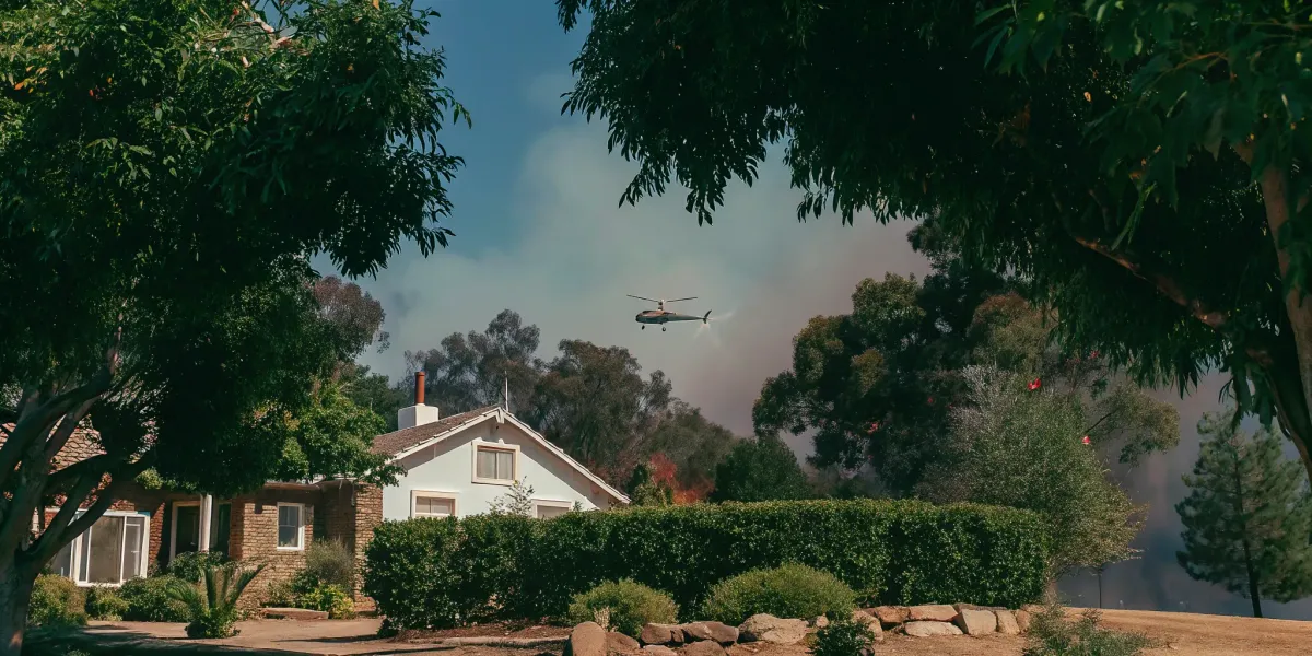 Helicopter over a home during a Northern California wildfire, a reminder to prepare for wildfire season.