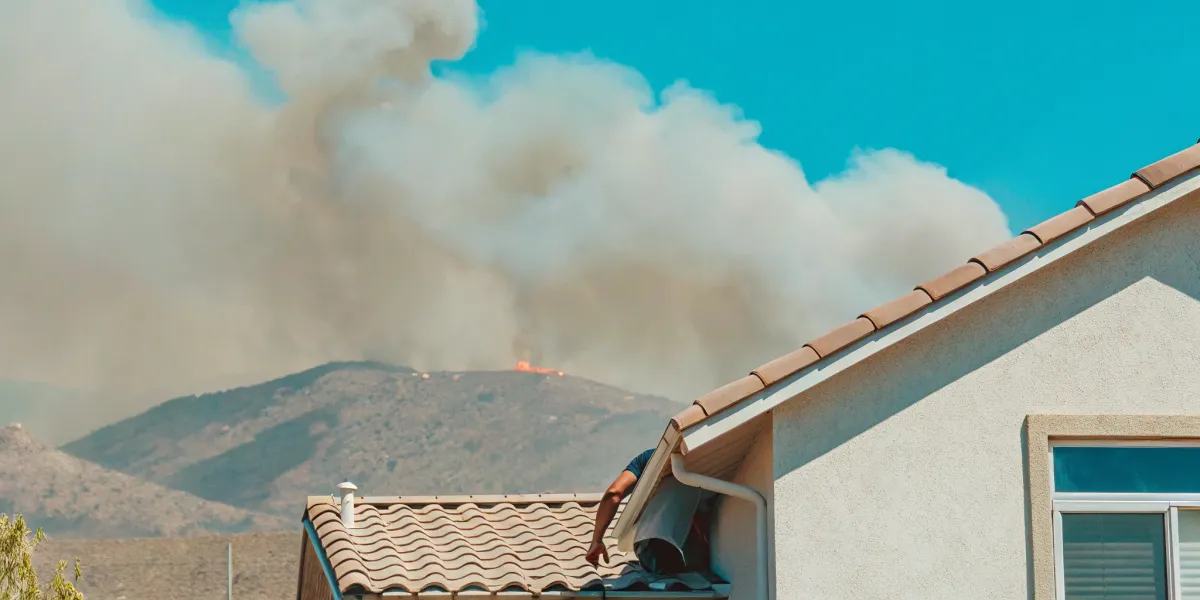 A home threatened by wildfire, a key reason for homeowners to have wildfire insurance coverage.