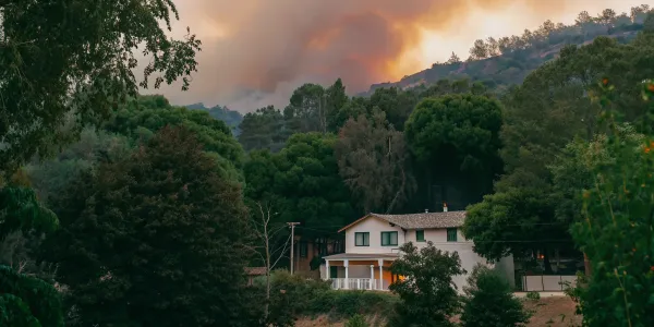 California house with wildfire smoke. Fire insurance is important.