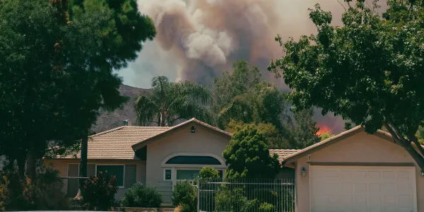 California house threatened by wildfire flames.