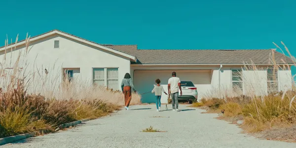 Family practices a fire evacuation drill at home, gathering at their safe meeting spot.