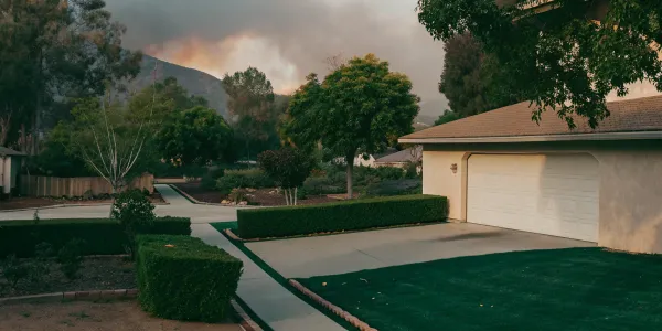 A suburban home with proper defensible space creation in its yard to reduce wildfire risk.